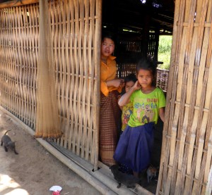Kavet people watching us from their bamboo house.