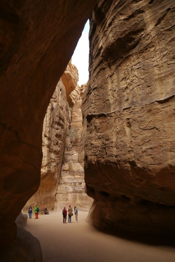 The cliffs close in on the track down Petra Siq